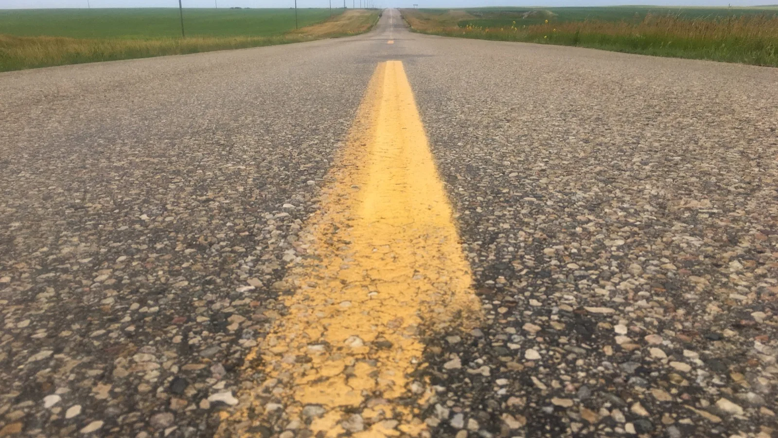 File photo: an empty rural prairie road near Foam Lake, Saskatchewan; not the scene of the collision.
